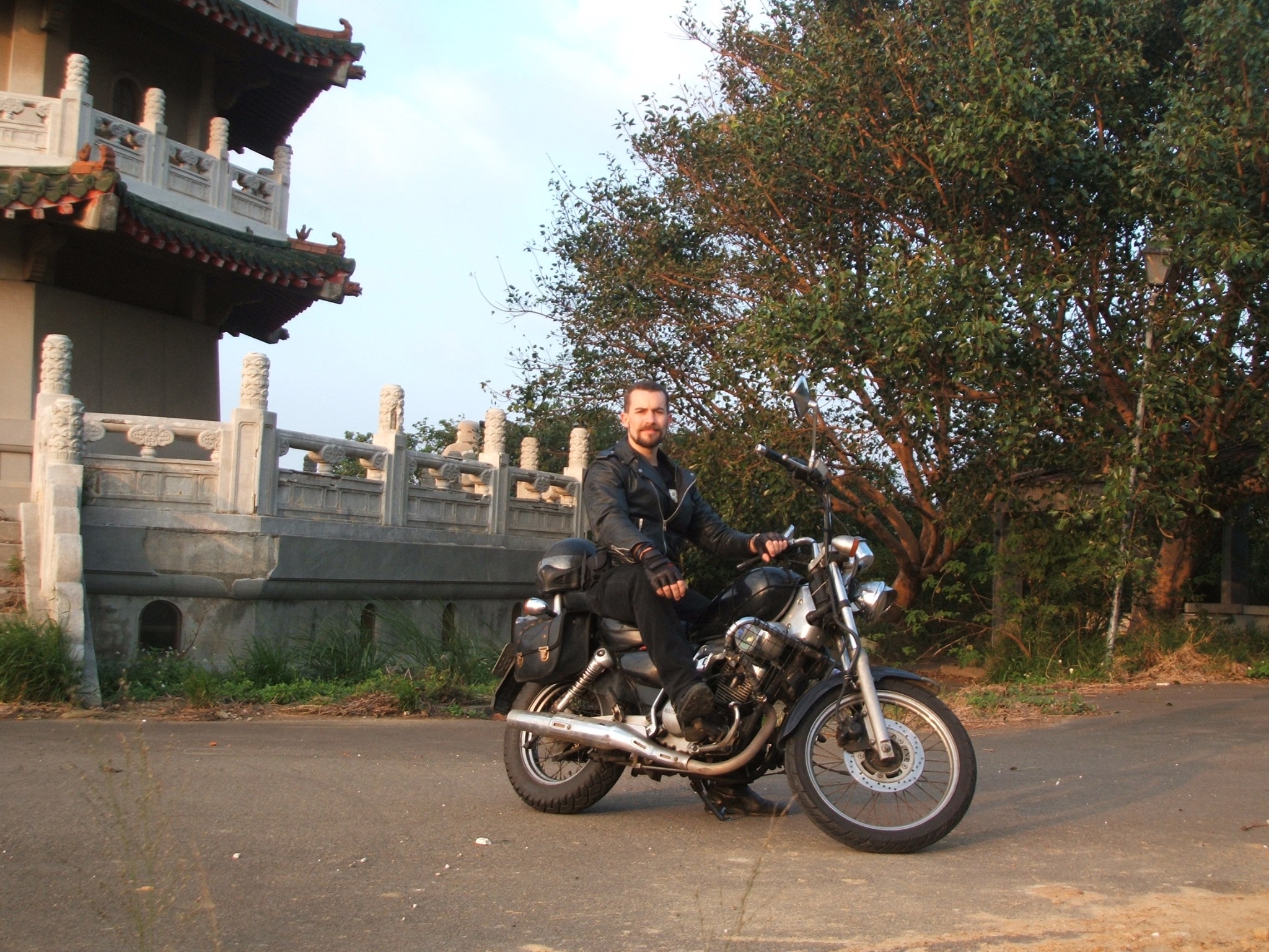Rick Carlile on motorcycle outside deserted pagoda in Hsinchu